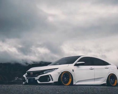 The white Honda Civic has excellent lowered style